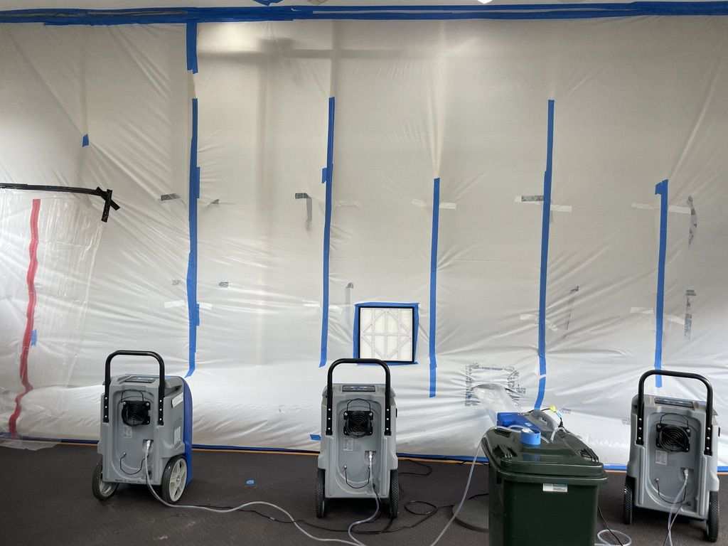 Containment and extraction setup during water damage response